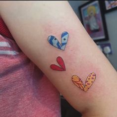 a woman's arm with three candy hearts on the left side of her arm