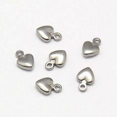 Breloques cœur argentées, dans un métal en acier inoxydable. Parfait pour les bracelets, pendentifs, boucles d'oreilles, tirettes de fermeture éclair, signets et porte-clés !

 Dimensions : 4 mm x 6 mm x 2 mm
 Taille du trou : 0,5 mm

 Vous recevrez 5 charmes.

 Besoin de plus? Envoyez-nous simplement un message via le formulaire de contact, le chat instantané ou à l'adresse mailto:info@bohemianfindings.com. Le prix de gros est disponible !

 Tous nos produits sont sans plomb et sans nickel. Com Make Your Own Bracelet, Craft Making, Metal Heart, Hand Stamped Jewelry, Small Pendant, Steel Metal, Metal Stamping, Charm Jewelry, Heart Charm