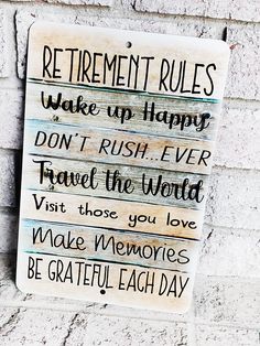 a sign on the side of a building that says retirement rules wake up happy don't rush ever travel the world visit those you love make memories be grateful each day