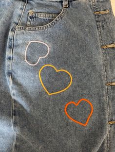 Original reworked upcycled Heart Skirt by Sensible Slacks. Vintage denim skirt with blue, yellow and orange hearts embroidered all over. Heart Skirt, Patchwork Denim Skirt, Vintage Denim Skirt, Street Punk, Skirt With Buttons, Patchwork Skirt, High Low Skirt, Embroidered Heart, Fringe Skirt