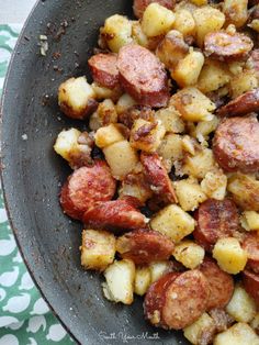 a bowl filled with potatoes and meat on top of a table