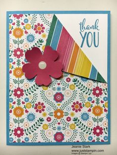 a colorful thank card with a flower on it