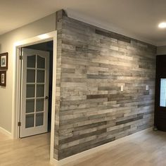 an empty room with wood paneling on the wall