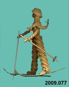 an image of a statue made out of rope and wood with two swords on it