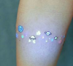 a person with tattoos on their legs that have planets and stars painted on them