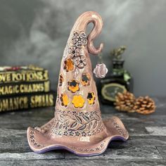 a ceramic witch hat sitting on top of a table