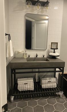 a bathroom with a sink, mirror and towel rack