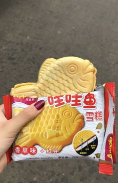 a person holding up a snack in their hand