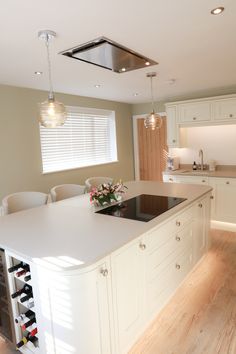 a kitchen with an island and wine rack