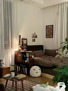 a living room filled with lots of furniture next to a white curtained window sill