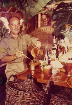 a man sitting at a table with some drinks in front of him