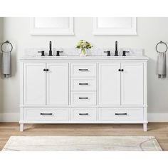 a white bathroom vanity with two sinks and mirrors