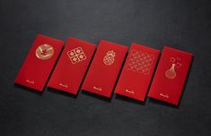 four red envelopes with gold designs on the front and back, lined up against a black background