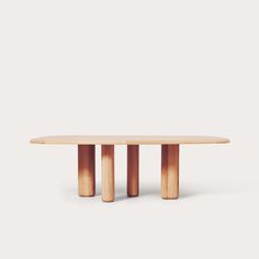 an oval wooden table with three columns on each side and one column at the end