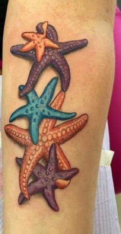 a woman's thigh with three starfishs on it and one in the middle