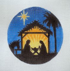 a cross stitch nativity scene with the birth of jesus and baby jesus in silhouette