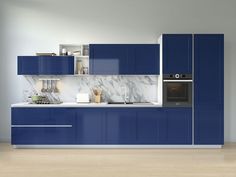 a modern kitchen with blue cabinets and marble counter tops, along with an oven in the center