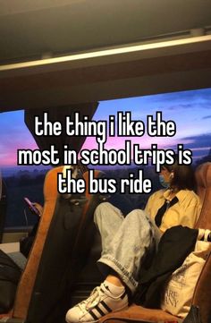 a man sitting in a chair with his feet up on the back of a bus