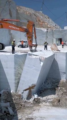 construction workers are working on the side of a large concrete structure that is being built