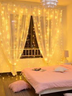 a bed room with a neatly made bed and lights on the windows sill above it