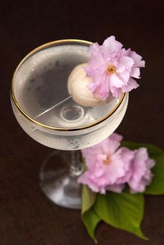 a close up of a drink with flowers in it