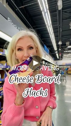 a woman holding up a piece of cheese board in her hand with the words more saving cheese board hacks on it