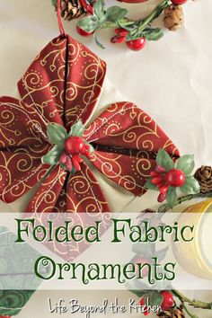 folded fabric ornaments with holly berries and pine cones