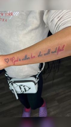 a person with a tattoo on their arm that says god within her, she will not fall