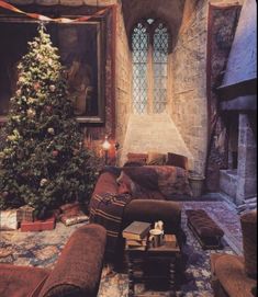 a living room filled with furniture and a christmas tree next to a fire place in a stone building