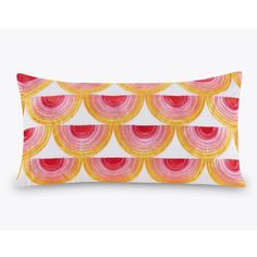 a pink and yellow pillow with circles on it