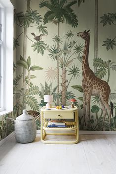 a giraffe is standing in front of a wall mural