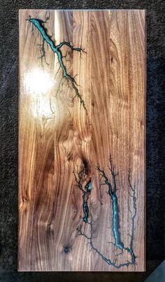 a wooden board with some blue water on top of it's woodgrain