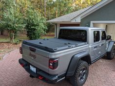 a gray truck parked in front of a house