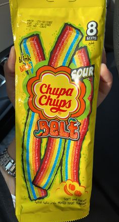 a person holding up a bag of chupa chips