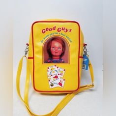 **New** Child’s Play 2 - Good Guy Box Bag This Incredible Bag Is Based On The Iconic Good Guys Doll Box And Is The Perfect Way To Show You Are A Real Friend ‘Till The End! Can Be Worn As A Shoulder Bag, Cross-Body, Or Backpack To Make It Comfortable For Everyone. Bag Details: -Light Padding In Front And Back Panels To Help Cushion Belongings And Provide Comfortable Wear. -Made Of Vegan Leather For Excellent Durability. -Design Details Include Embossed Lettering, Patch Applique, And Sewn-In Window Image. -Good Guy Shoe Print Pvc Zipper-Pull On The Main Compartment. -Good Guy Striped Shirt Pattern Fabric Lining. -Pockets -1 Large Main Zipper Compartment With Inner Pockets. -Front Open Playful Yellow Shoulder Bag For School, Novelty Yellow Bag For Everyday Use, Playful Yellow Bags For Back To School, Retro Yellow School Bag, Retro Yellow School Bags, Fun Yellow Backpack Bag, Back To School Yellow Shoulder Bag, Fun Yellow Backpack, Yellow Shoulder Bag For Back To School