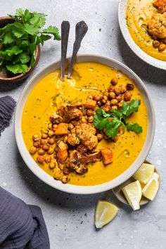 two bowls filled with soup and garnished with cilantro