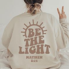 Be the Light Sweatshirt Gift for Christians Mathew 5:14 - Etsy Things To Put On Sweatshirts, Be The Light Sweatshirt, Biblical Sweatshirts, Christian Sweatshirts Hoodie, Be The Light Shirt Design, Cute Christian Sweatshirt Designs, Faith Shirt Ideas, Cute Sweatshirts Christian, Cute Cricut Sweatshirt Ideas