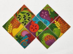 four square tiles with colorful designs on them