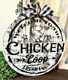 a chicken coop sign sitting on top of a wooden table