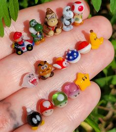 there are many small toy animals in the hand