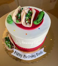 a birthday cake that has some food on it