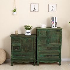 two green wooden dressers sitting next to each other in front of a wall with pictures on it