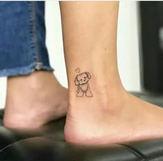 a small dog tattoo on the ankle