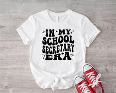 In My School Secretary Era T-Shirt, School Office Shirt, Back To School Tee, School Secretary Appreciation T-Shirt, Gift for Secretary Shirt Welcome to Crazy Hat Shop,  Your go-to destination for unique and eye-catching printed t-shirts! We specialize in high-quality, creatively designed tees that let you express your individuality and stand out from the crowd. Whether you're looking for bold graphics, witty slogans, or artistic prints, our diverse collection has something for everyone. Discover your next favorite t-shirt at Crazy Hat Shop, where crazy cool meets everyday comfort! School Secretary Appreciation, Crazy Hat, School Secretary, Office Shirt, Crazy Hats, School Tees, The Office Shirts, My School, Printed T Shirts