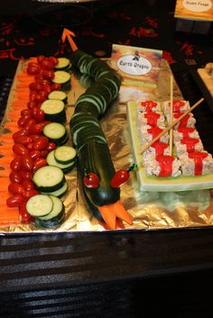 an assortment of vegetables on a tray ready to be cut and served at a party