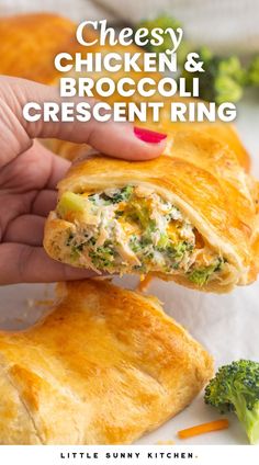 a hand holding a piece of chicken and broccoli crescent ring