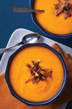 two bowls filled with soup on top of a table