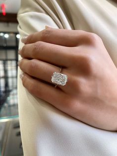 a woman's hand with a diamond ring on it