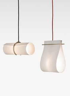 three lamps hanging from the ceiling in different shapes and sizes, one with a red cord