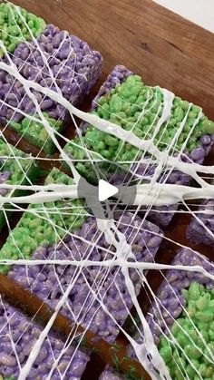 purple and green desserts with white icing on them